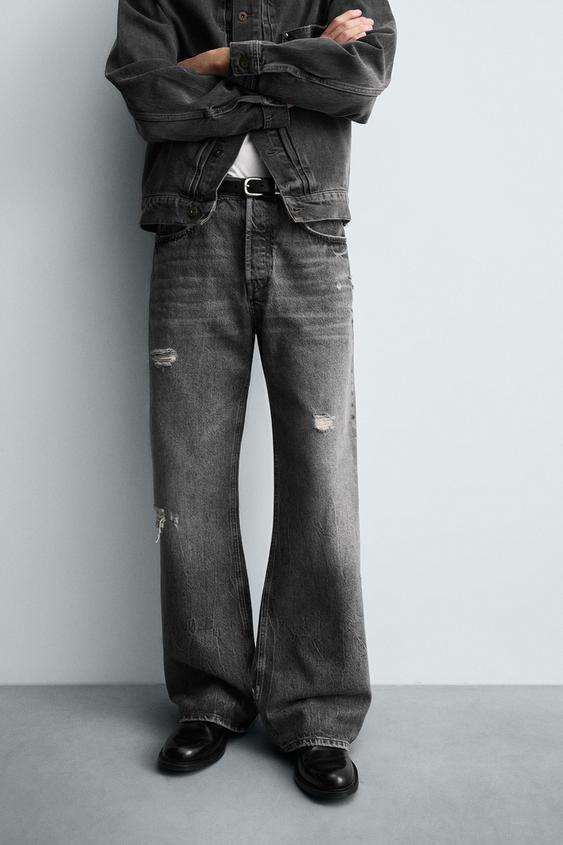 Jeans graffiati grigi a zampa